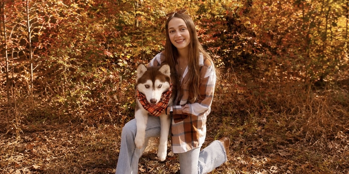 Samantha with Bueller in an autumn forest